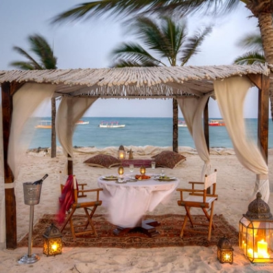 Dinner table in fornt of the sea on the beach of Billionaire Resort & Retreat